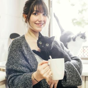 happy-woman-with-cup-coffee-holding-her-cat_23-2147860403.jpg